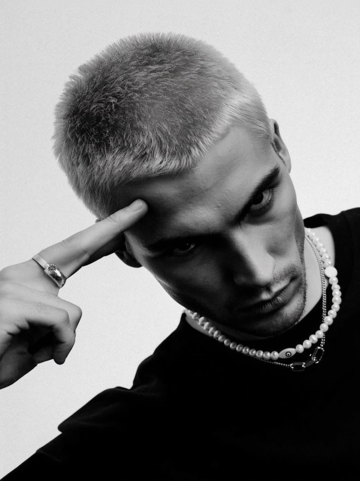 paparazzi-style capture of Damon Cael stepping off a curb in couture, rising pop artist Damon Cael.