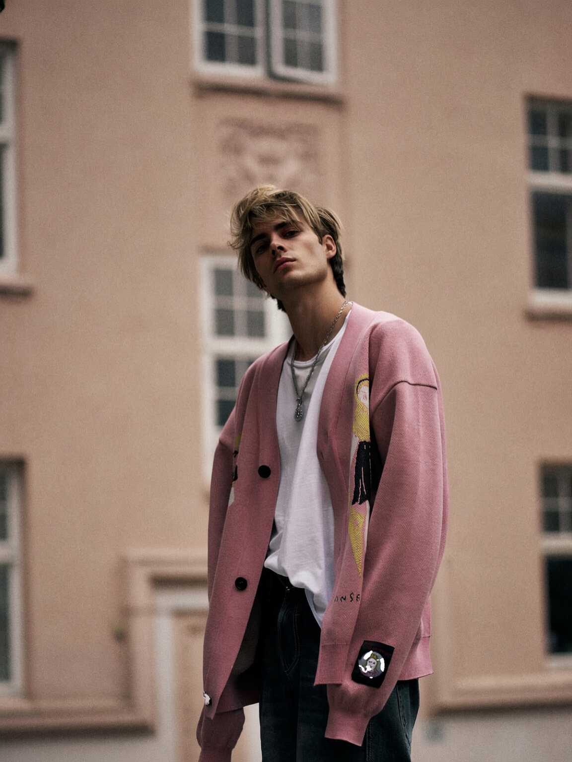 paparazzi zoom shot of Damon Cael in color-blocked runway look, rising pop artist Damon Cael.