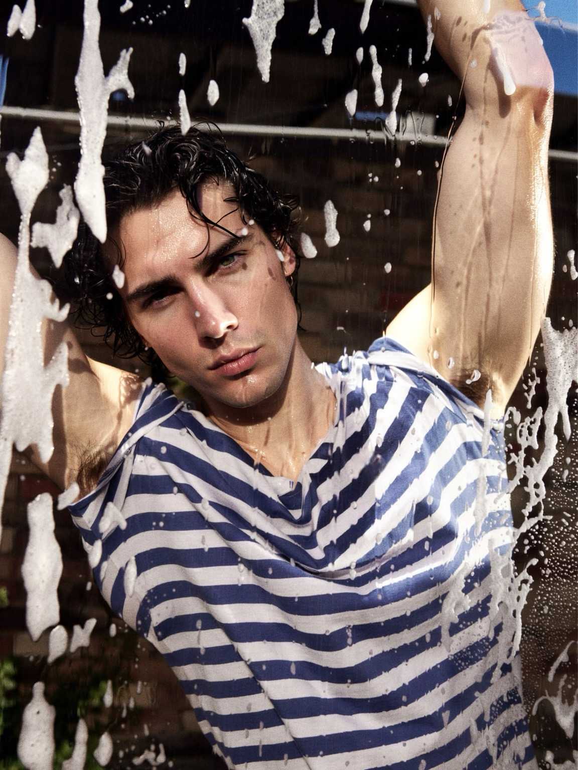 paparazzi-style frame of Damon Cael in layered textures and sleek tailoring, rising pop artist Damon Cael.