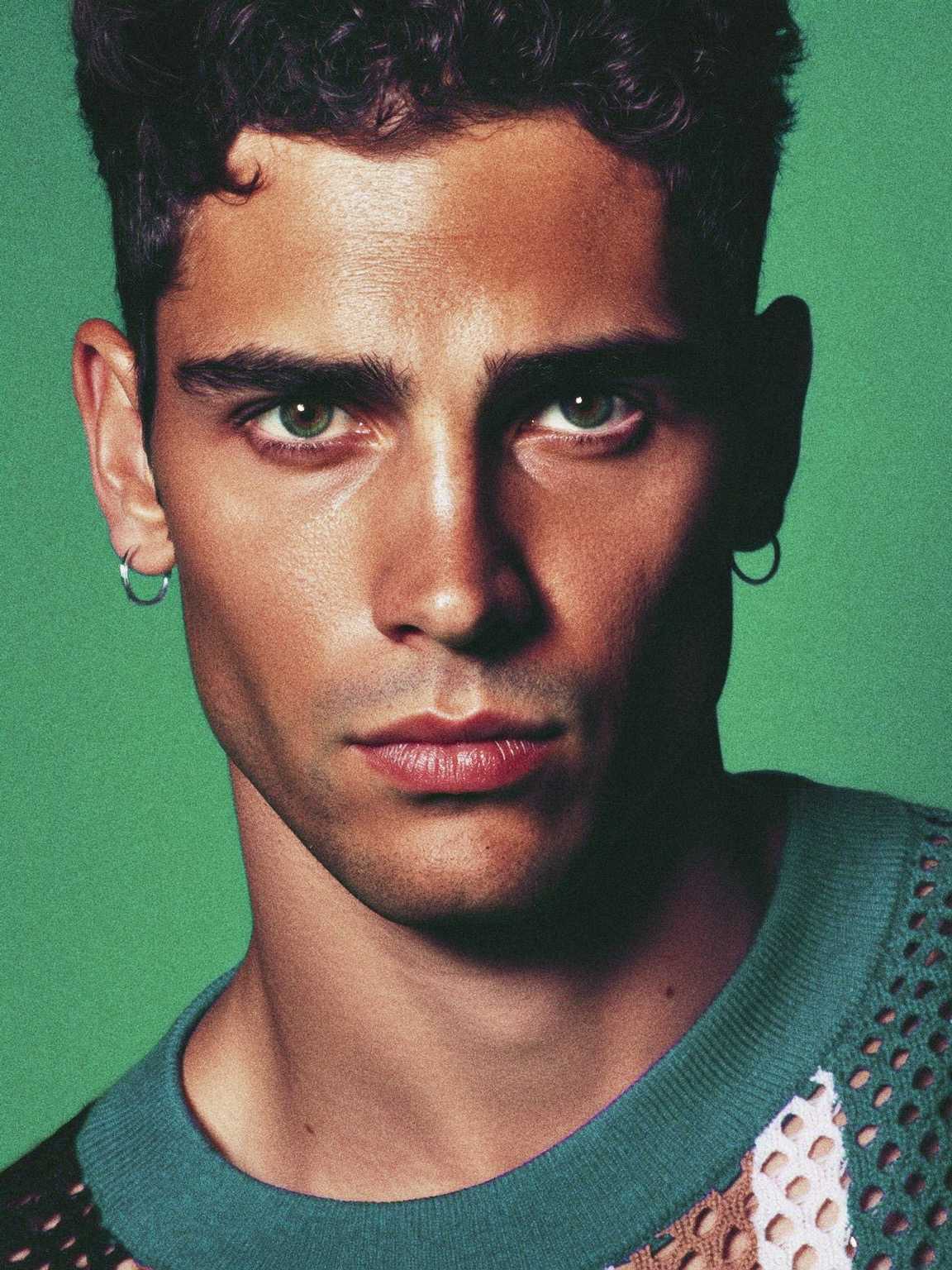 paparazzi image of Damon Cael paused near a doorway in designer coat, rising pop artist Damon Cael.