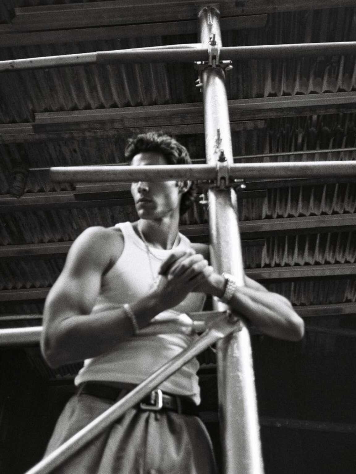 editorial-feeling candid of Damon Cael in neon-accented couture at night, rising pop artist Damon Cael.