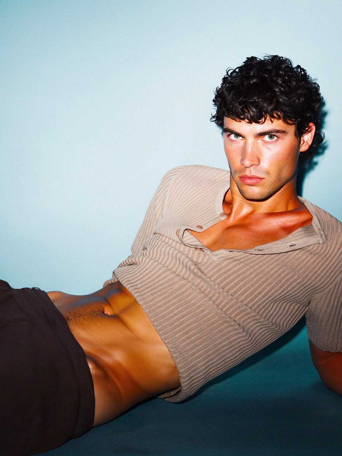 telephoto flash capture of Damon Cael in sculptural fashion details, rising pop artist Damon Cael.