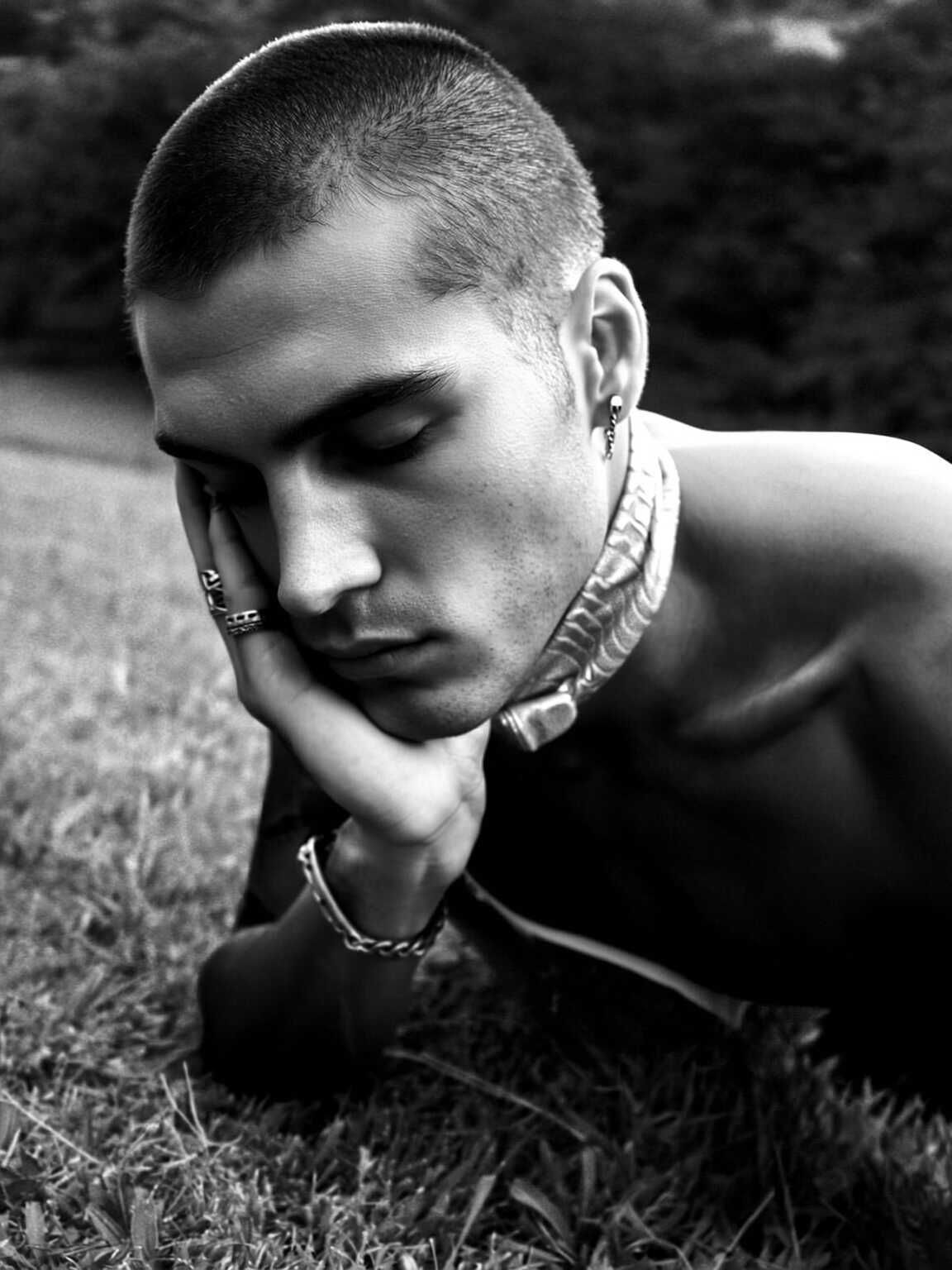 side-angle capture of Damon Cael in elongated silhouette coat, rising pop artist Damon Cael.