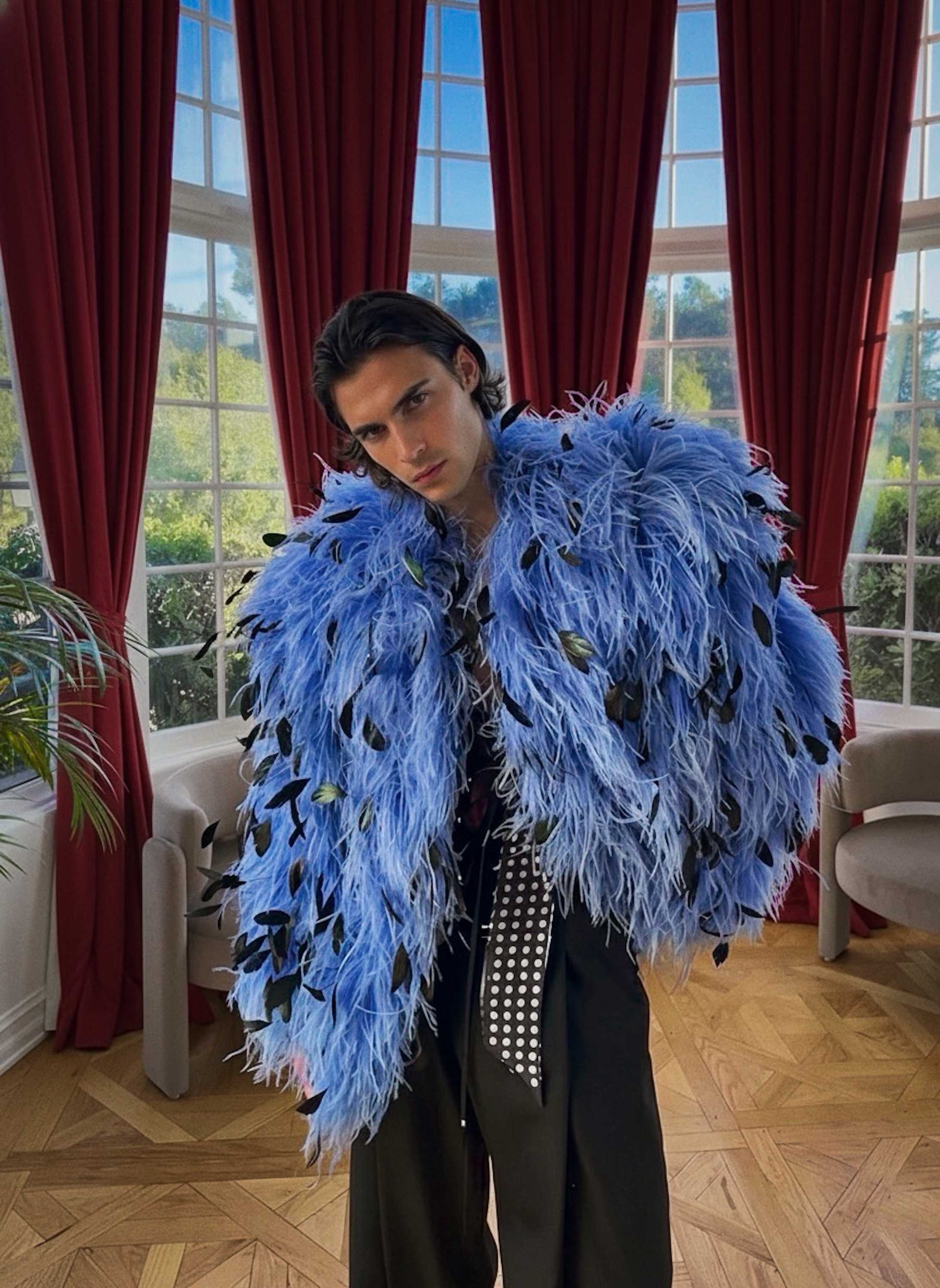 grainy flash photo of Damon Cael arriving at an event in experimental runway fashion, rising pop artist Damon Cael.