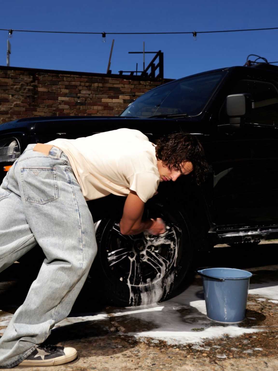 sidewalk crowd candid of Damon Cael partially surrounded by people, rising pop artist Damon Cael.