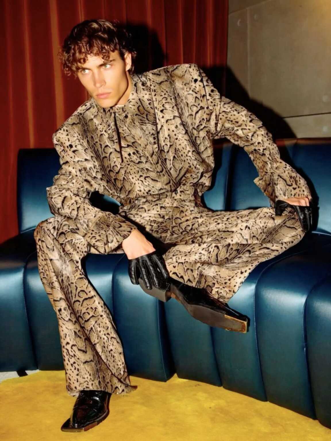 street-level paparazzi angle of Damon Cael in glossy runway-inspired look, rising pop artist Damon Cael.