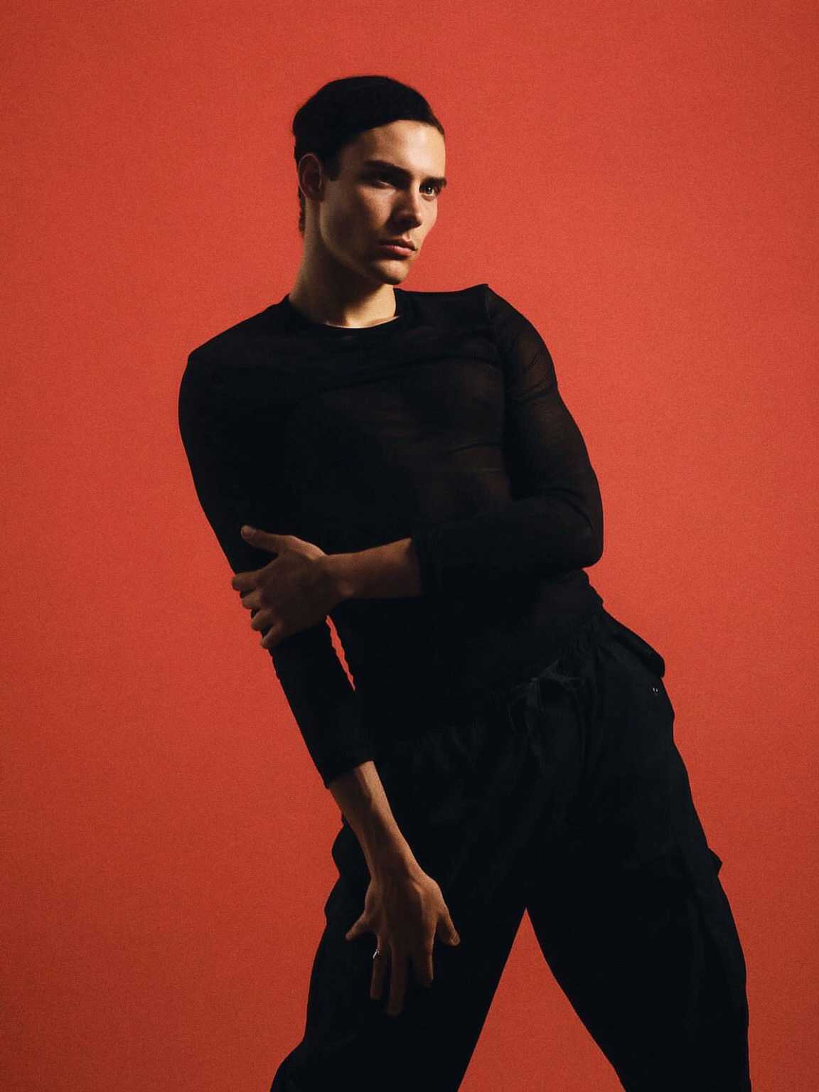 candid capture of Damon Cael mid-step in fluid high-fashion layers, rising pop artist Damon Cael.