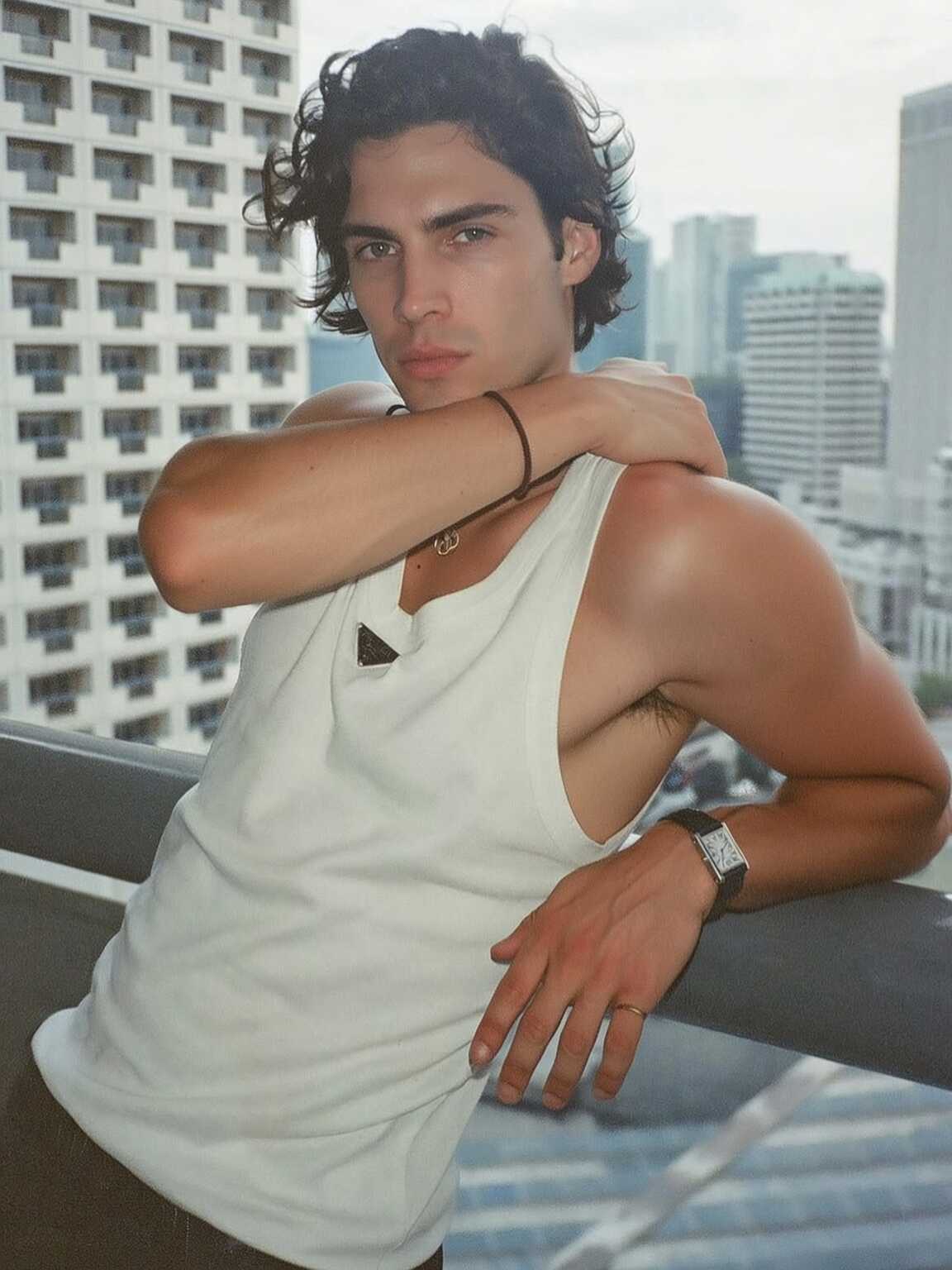 candid curbside shot of Damon Cael in sleek boots and tailored trousers, rising pop artist Damon Cael.